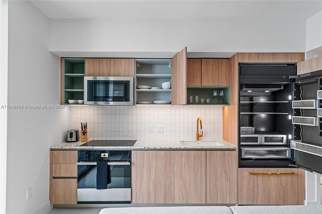 601 NE 1st Ave Unit 3101, Miami, FL 33132 - kitchen with a sink, open shelves, modern cabinets, stainless steel appliances, and decorative backsplash