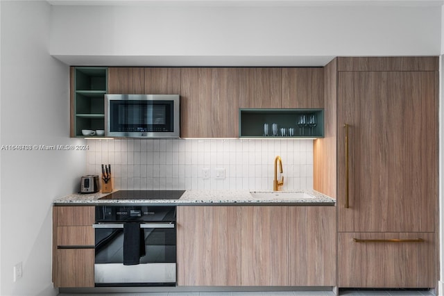 601 NE 1st Ave Unit 3101, Miami, FL 33132 - kitchen featuring decorative backsplash, modern cabinets, stainless steel appliances, and open shelves