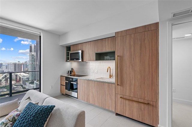 601 NE 1st Ave Unit 3101, Miami, FL 33132 - kitchen featuring open shelves, backsplash, a sink, visible vents, and appliances with stainless steel finishes
