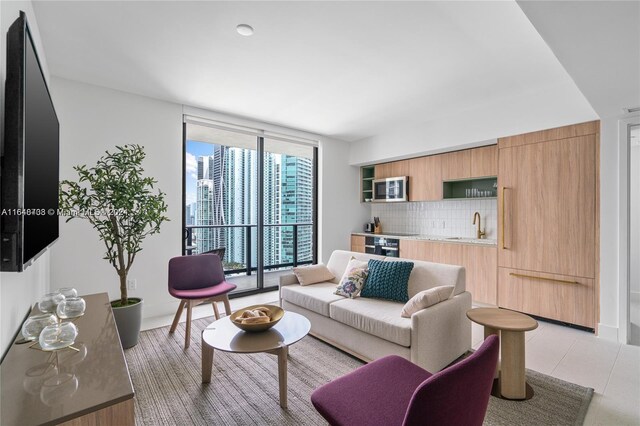 601 NE 1st Ave Unit 3101, Miami, FL 33132 - living area featuring baseboards, floor to ceiling windows, and bar