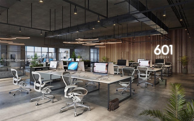 office space featuring a high ceiling, concrete flooring, and wood walls