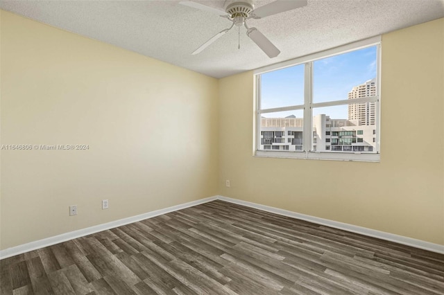 unfurnished room with a textured ceiling, ceiling fan, and dark hardwood / wood-style flooring