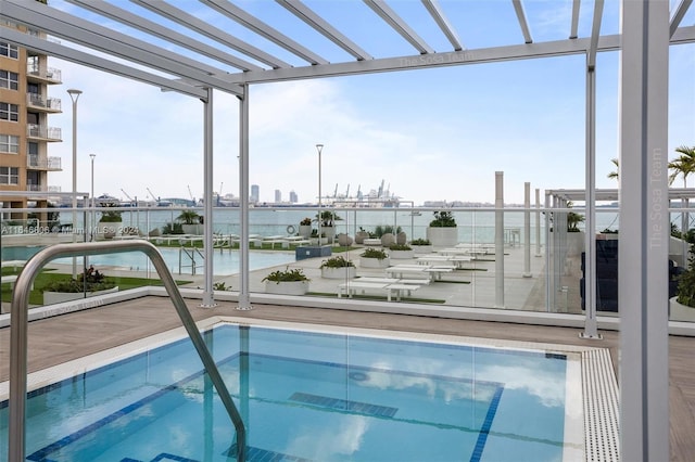 view of pool featuring a water view and a pergola