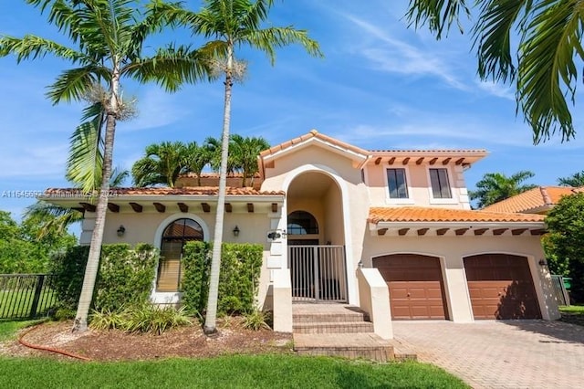 mediterranean / spanish-style house with a garage