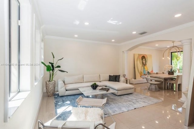 living room featuring decorative columns, light tile patterned floors, and ornamental molding