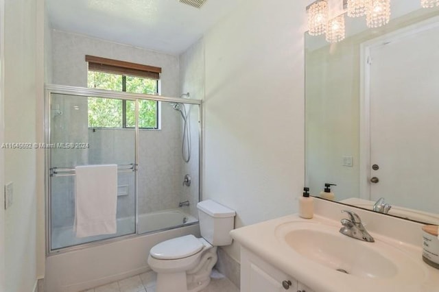 full bathroom featuring toilet, tile patterned flooring, a notable chandelier, combined bath / shower with glass door, and vanity