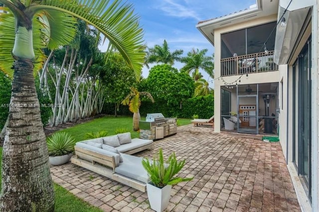 view of patio / terrace featuring an outdoor living space, grilling area, and a sunroom