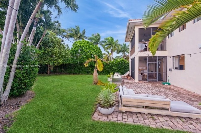 view of yard with a patio and a sunroom