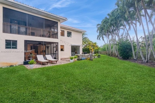 back of property with a patio area and a lawn