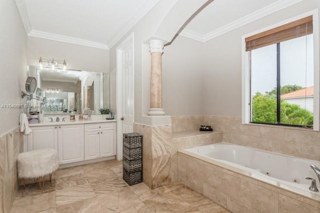 bathroom featuring a relaxing tiled tub, vanity, ornate columns, and ornamental molding