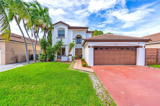 mediterranean / spanish-style house with a front yard and a garage