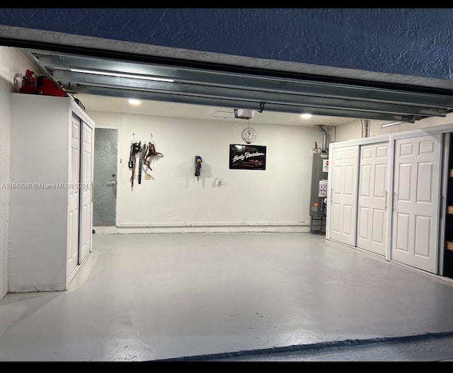 garage featuring gas water heater and a garage door opener