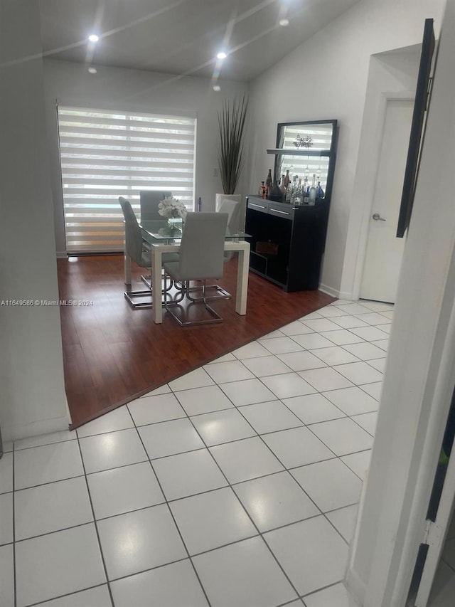 dining room featuring vaulted ceiling and wood-type flooring