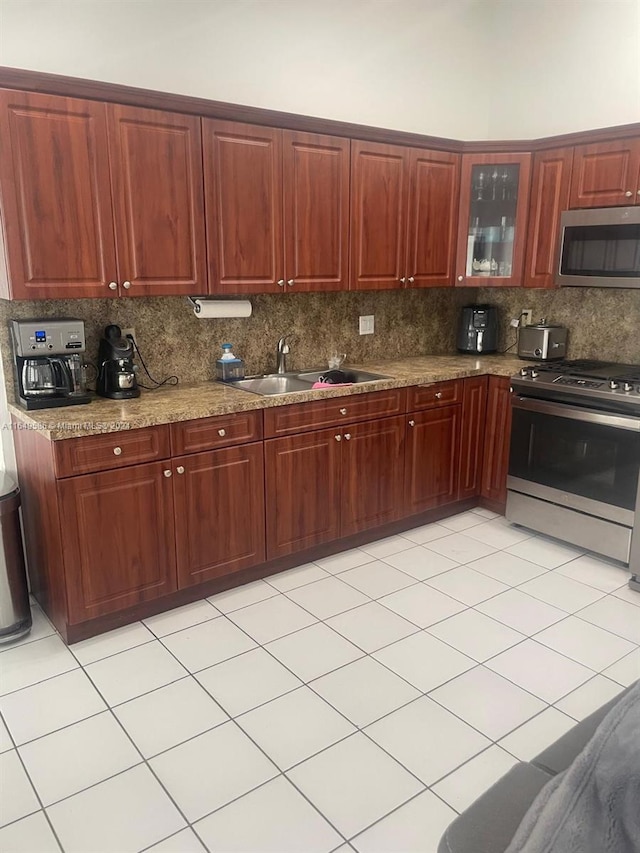 kitchen featuring sink, stainless steel appliances, and decorative backsplash