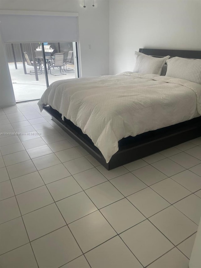 bedroom featuring access to exterior and light tile patterned flooring