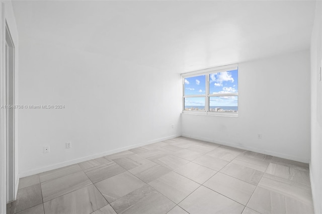 unfurnished room with light tile patterned floors