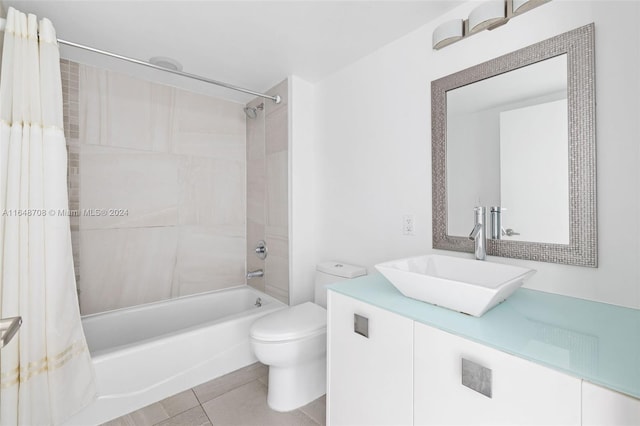 full bathroom featuring shower / bath combination with curtain, tile patterned flooring, vanity, and toilet