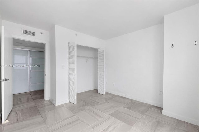 unfurnished bedroom with a closet