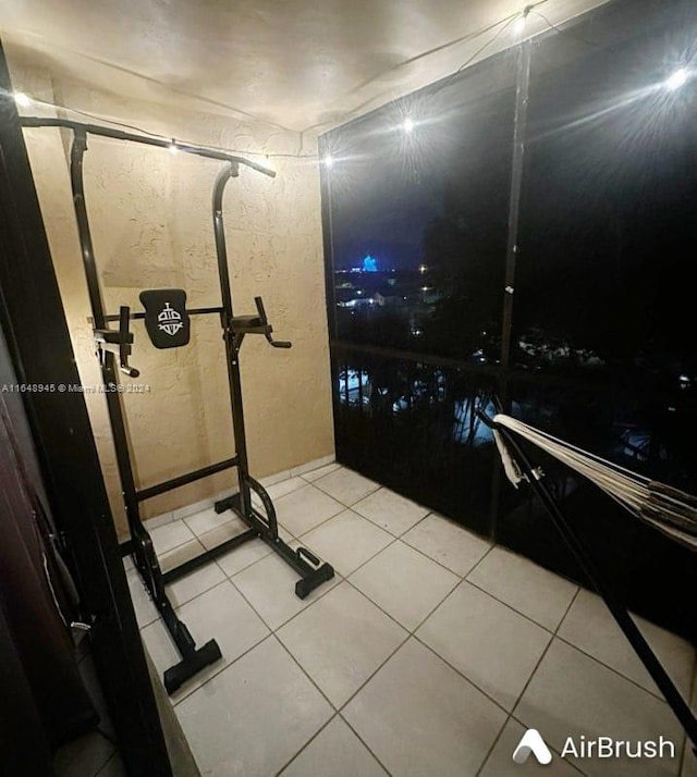 workout area featuring light tile patterned floors