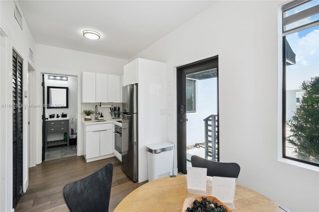 dining area featuring dark wood-type flooring and sink