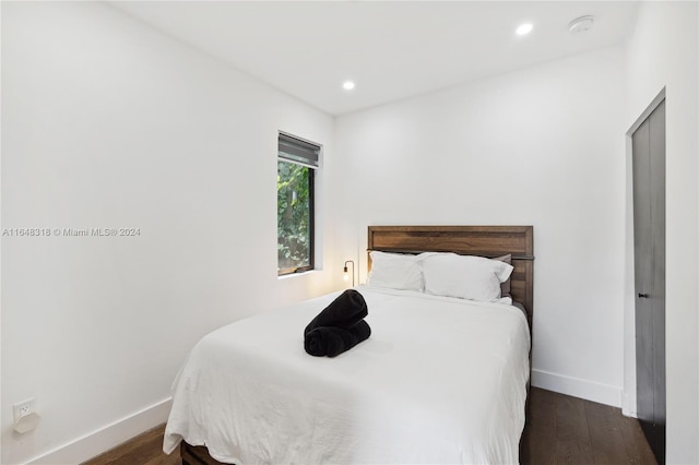 bedroom featuring dark hardwood / wood-style flooring