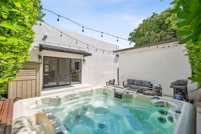 view of pool with a hot tub and an outdoor hangout area