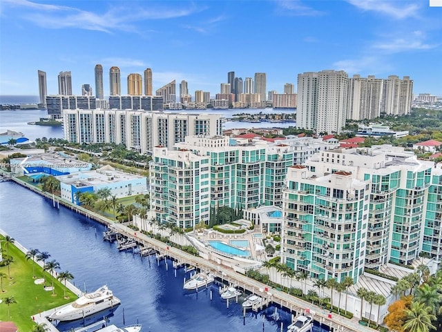 birds eye view of property featuring a city view and a water view