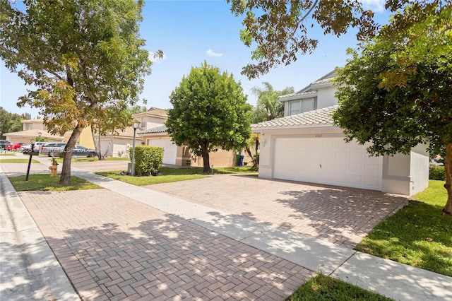 view of property hidden behind natural elements with a garage