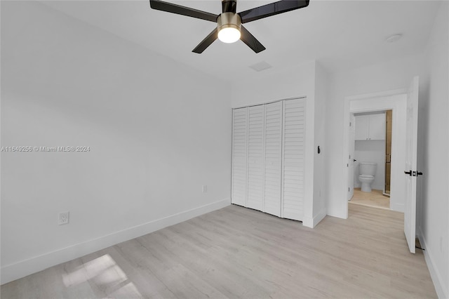 unfurnished bedroom with light hardwood / wood-style flooring, ceiling fan, a closet, and connected bathroom