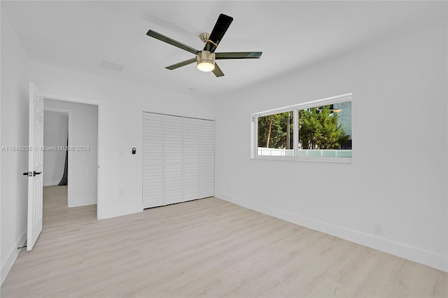 unfurnished bedroom featuring ceiling fan, a closet, and light hardwood / wood-style floors