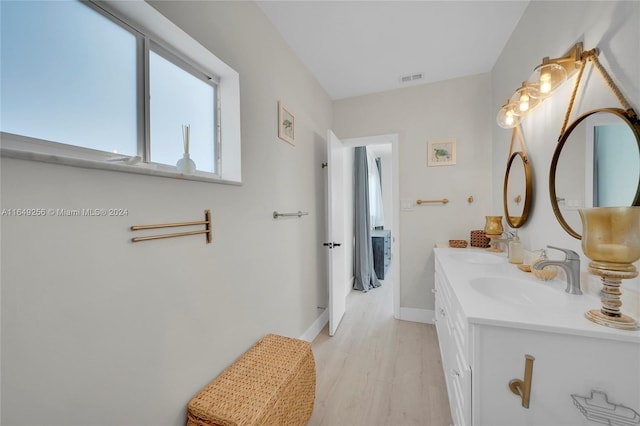 bathroom with vanity and wood-type flooring