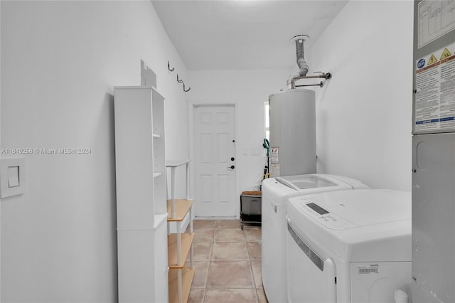 clothes washing area with gas water heater, separate washer and dryer, and light tile patterned flooring