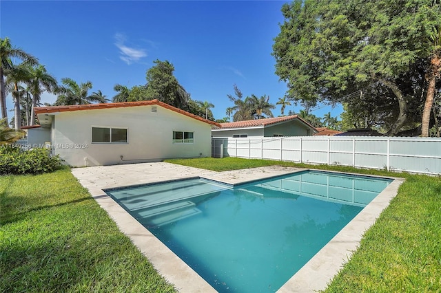 view of swimming pool with a patio area and a lawn