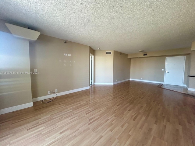 interior space featuring a textured ceiling and light wood-type flooring