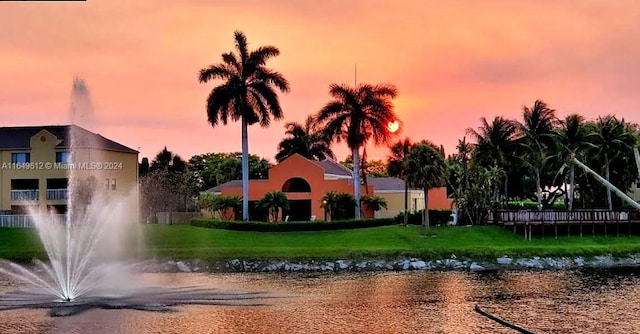 view of property's community featuring a water view and a lawn