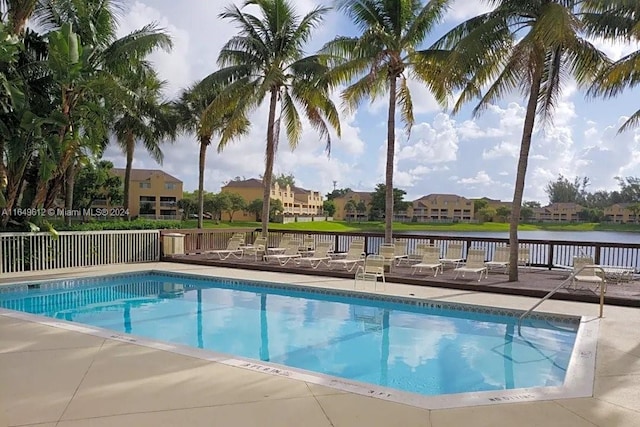 view of pool featuring a water view