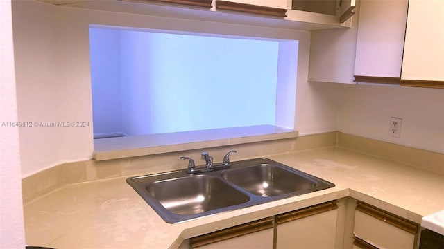 kitchen with white cabinetry and sink