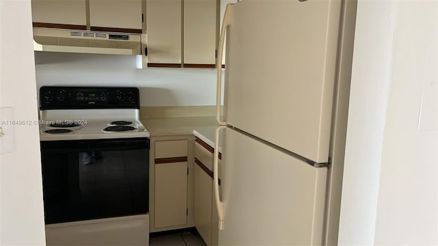 kitchen featuring exhaust hood and white appliances