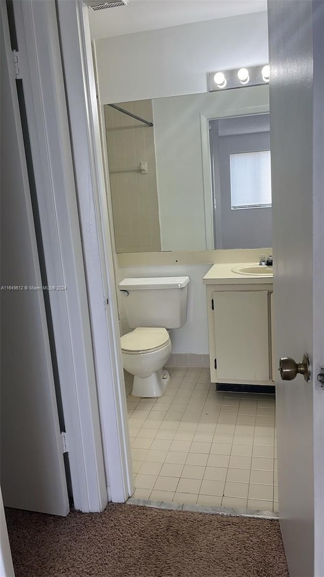 bathroom featuring vanity, toilet, and tile patterned floors