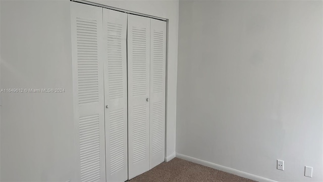 unfurnished bedroom with carpet and a closet