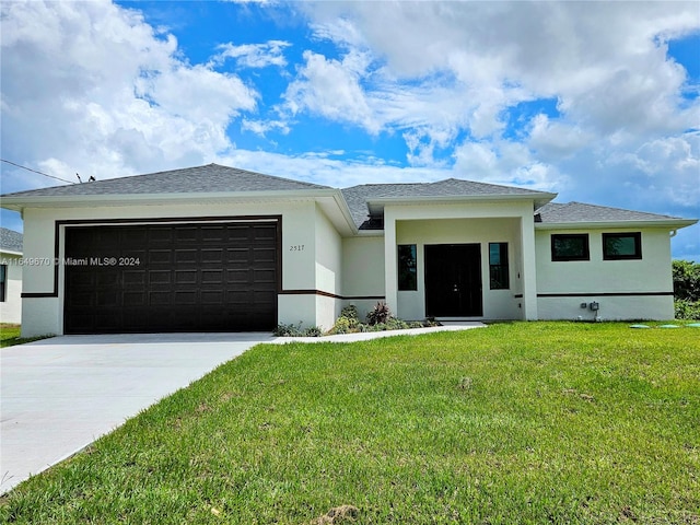 view of front of home featuring a front lawn and a garage