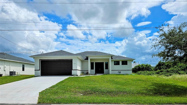 view of front facade featuring central AC unit, a garage, and a front yard