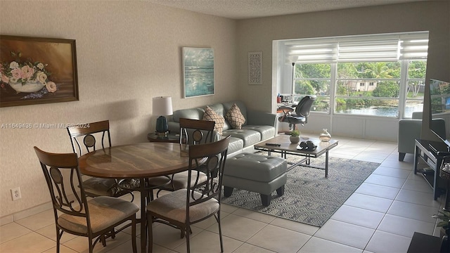 living room featuring a textured ceiling and light tile patterned floors