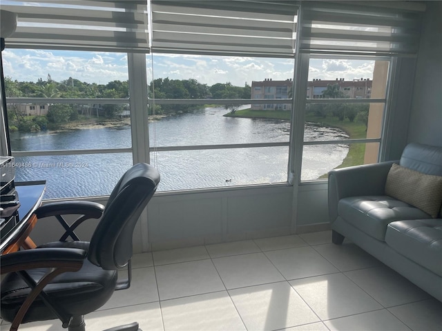 sunroom / solarium featuring a water view