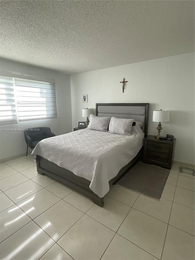 tiled bedroom with a textured ceiling