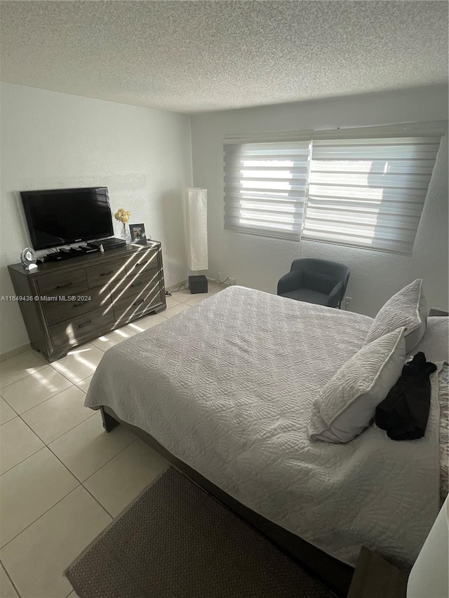 tiled bedroom with a textured ceiling