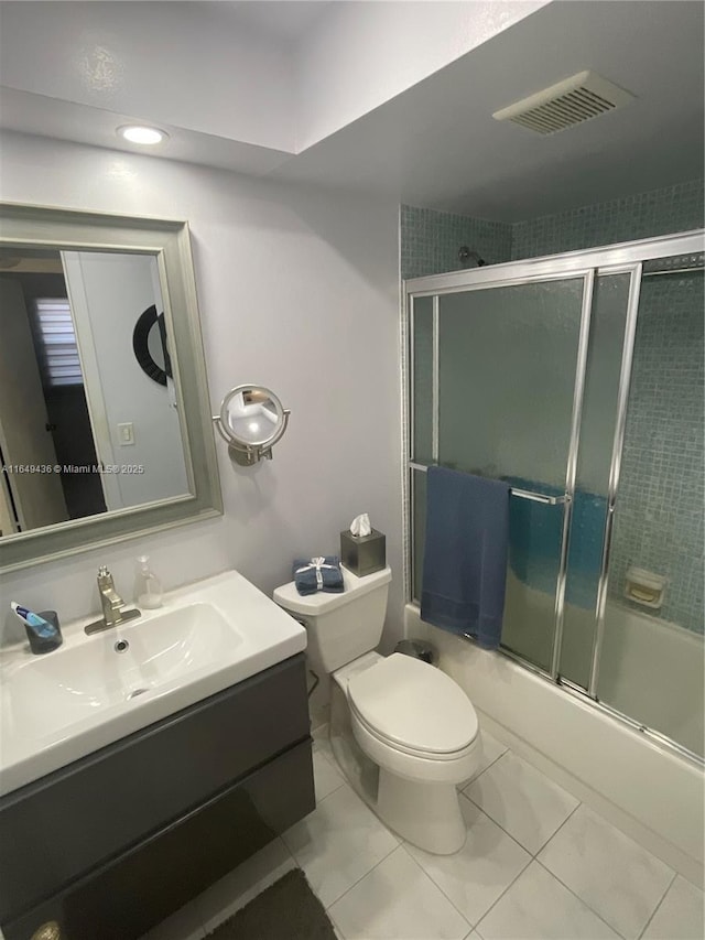 bathroom featuring combined bath / shower with glass door, visible vents, toilet, and vanity