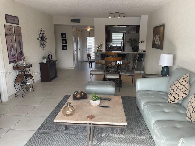 tiled living room with a textured ceiling