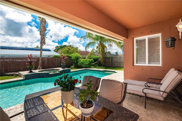 view of swimming pool featuring an in ground hot tub and a patio area