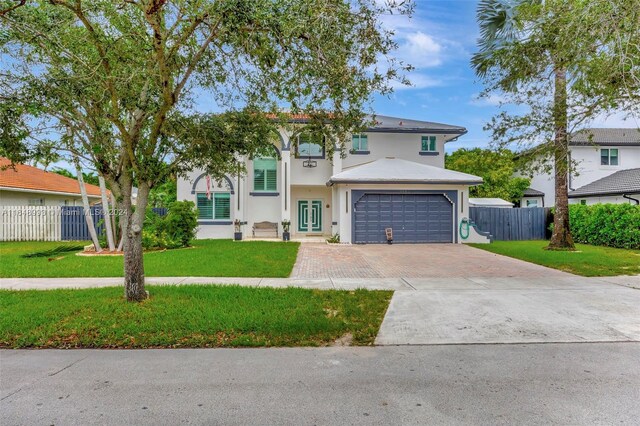 view of front facade featuring a front yard and a garage